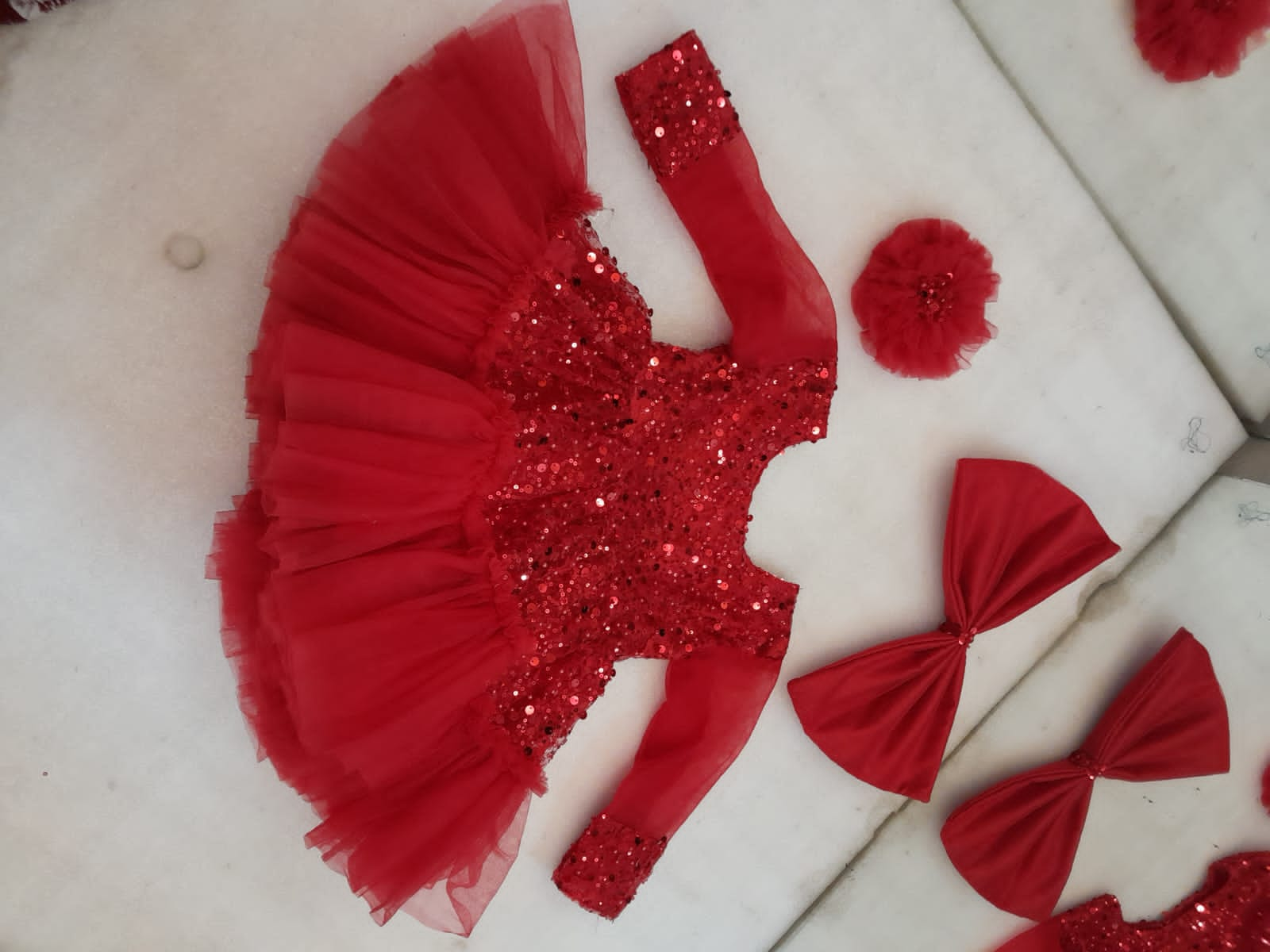 Red colour sequin frock with big bow and hair accessory